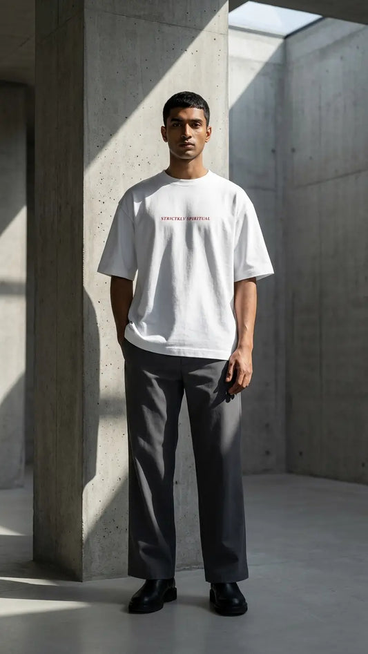 Man wearing a white t-shirt with text in a minimalistic setting
